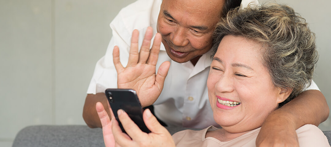 senior couple video chatting with family